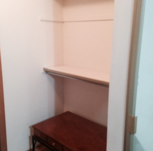 Empty clean closet with shelf and bench after